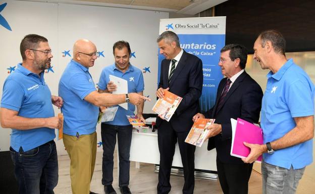 El presidente de la Diputación, Cesar Rico -segundo a la derecha-, y el director territorial de Caixabank en Castilla y León y Asturias, Marc Benhamou -a la derecha-, acompañados por voluntarios de La Caixa