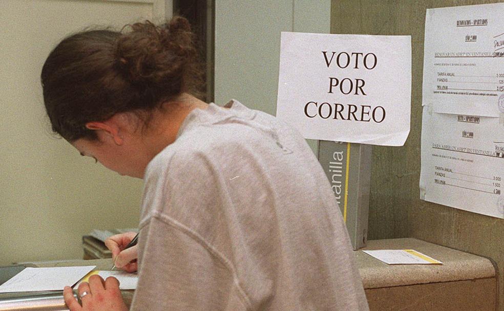 Una mujer realiza los trámites para ejecutar su voto por correo. 