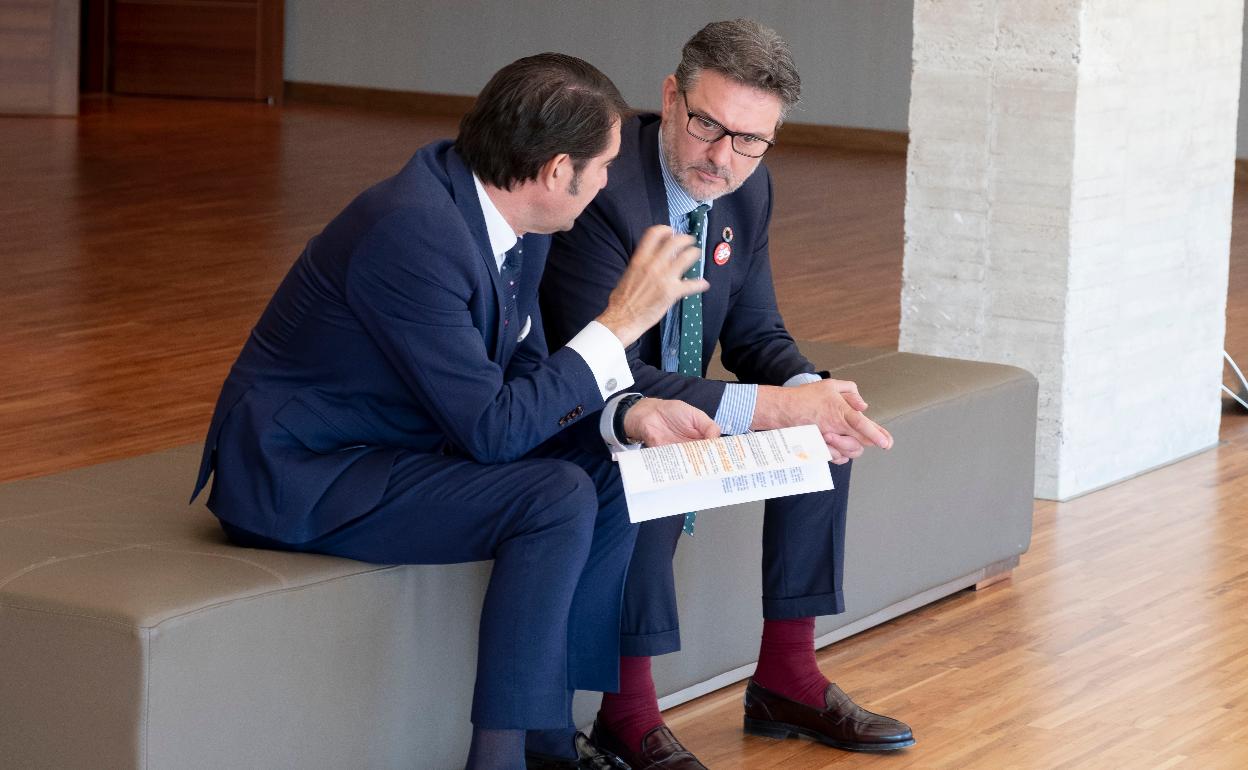 El consejero Suárez-Quiñones conversa con el socialista José Luis Vázquez, en el vestíbulo de acceso al hemiciclo de las Cortes.