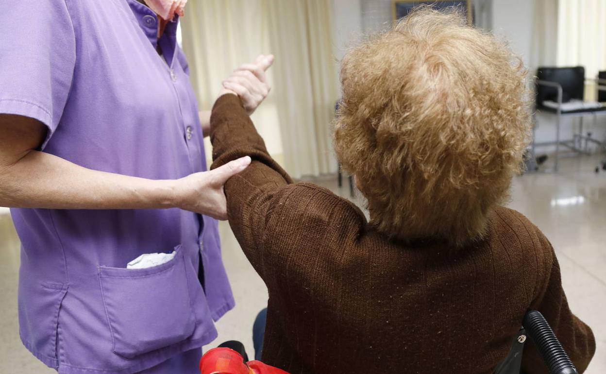 Una mujer es atandida en una residencia de ancianos. 