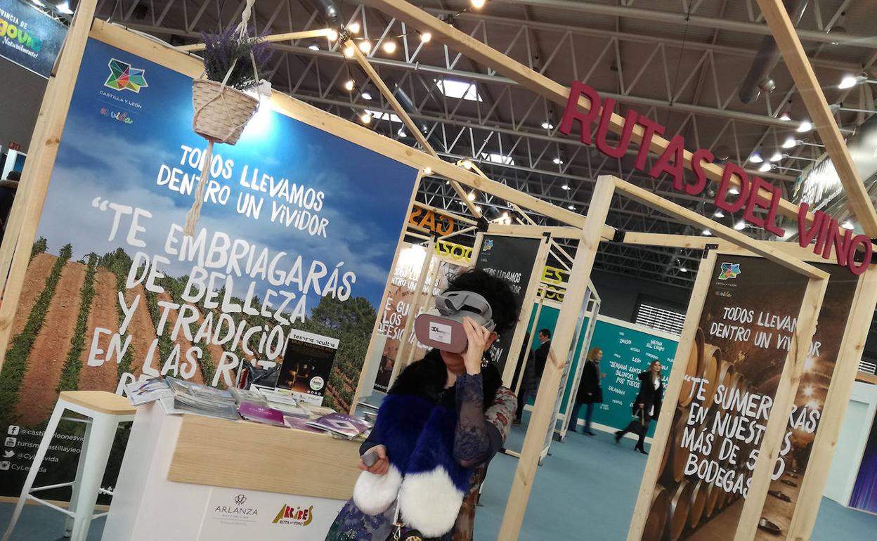 Una mujer observa la realidad aumentada a través de unas gafas, en Fitur