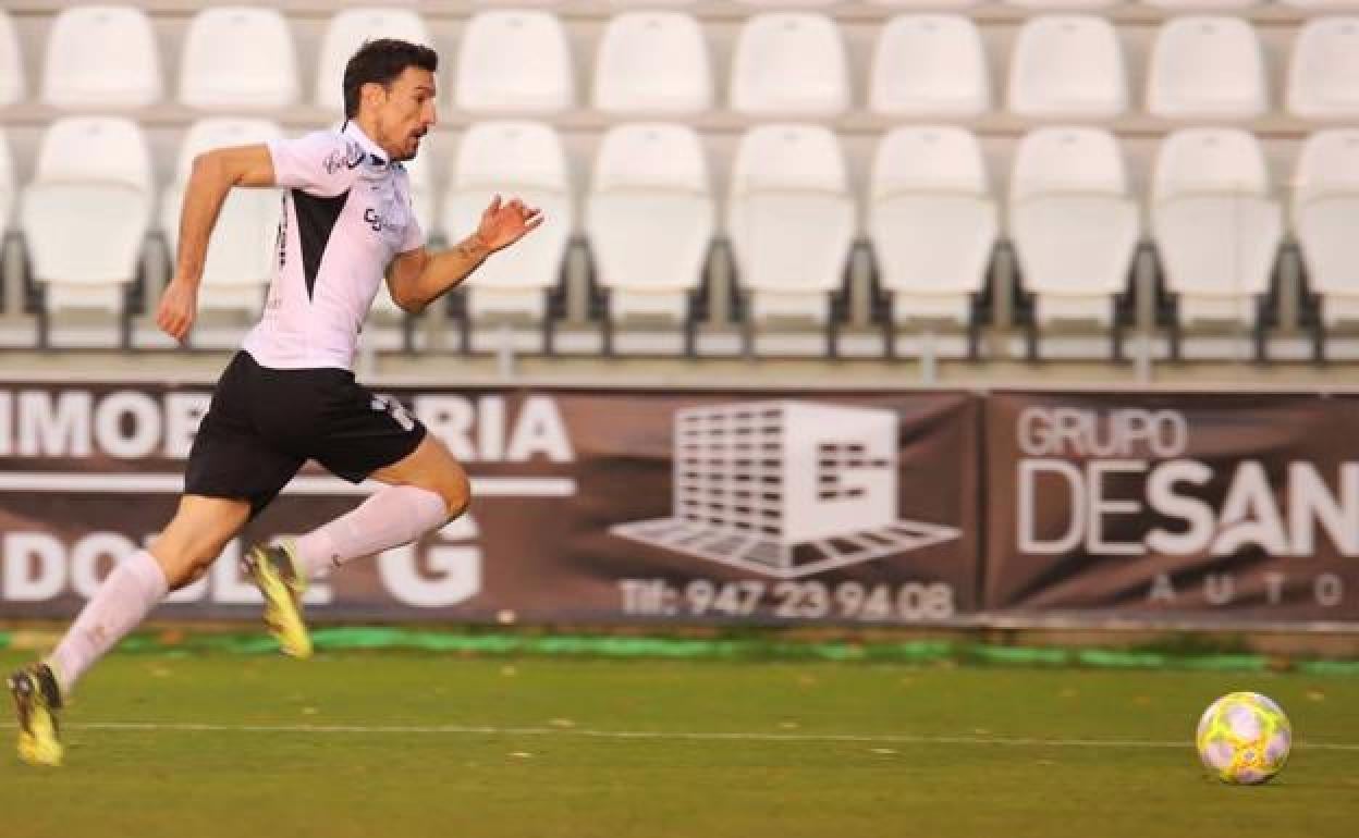 Toche, intentando llegar a un balón en un partido con el Burgos CF. 