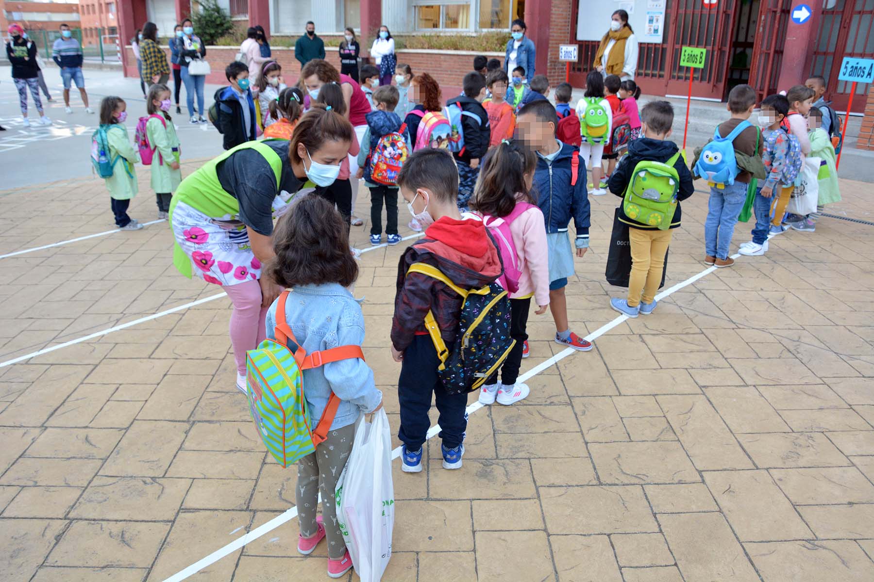 Decenas de niños esperan pacientemente en la calle antes de entrar en el colegio Jueces de Castilla. 