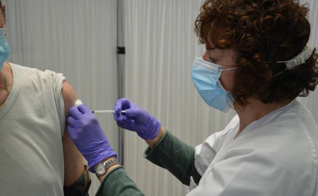 Una sanitaria administra la vacuna a un ciudadano. 