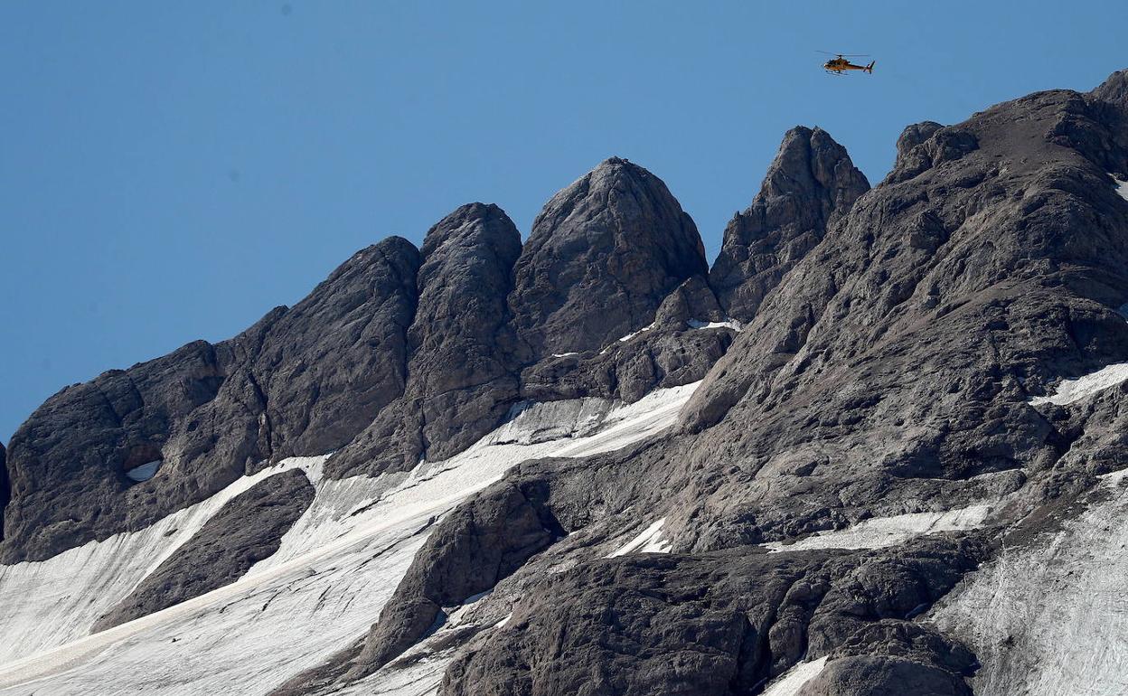 Un helicóptero sobrevuela la Marmolada, donde el domingo una avalancha se cobró la vida de al menos siete personas