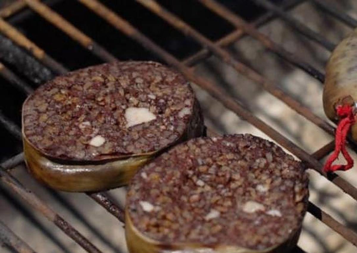 Imagen secundaria 1 - Alubias rojas, morcilla y el jurado catando una de las pucheras en una edición pasada. 