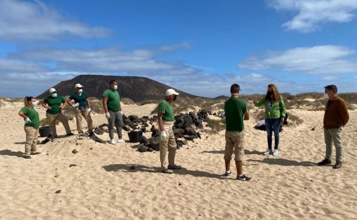 Lola García, con los trabajadores del plan de empleo en las playas de Lobos. 
