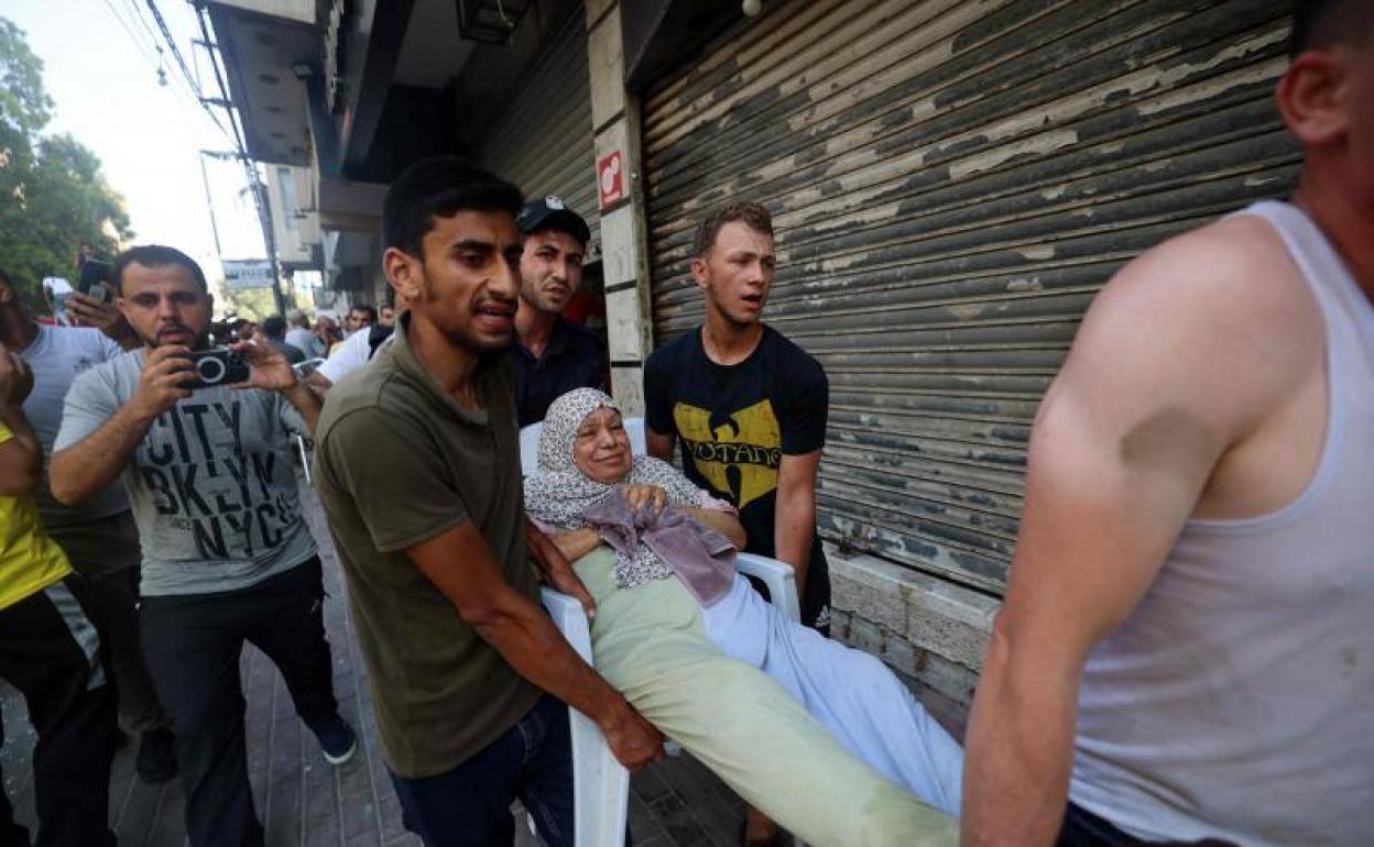 Una mujer palestina herida es trasladada este viernes después de un bombardeo israelí en la Franja de Gaza