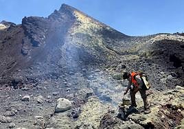 Un investigador toma muestras en una fractura en el cono del Tajogaite.