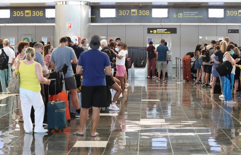 Cientos de turistas hacen cola en el aeropuerto de Gran Canaria para tomar los vuelos de regreso a sus países