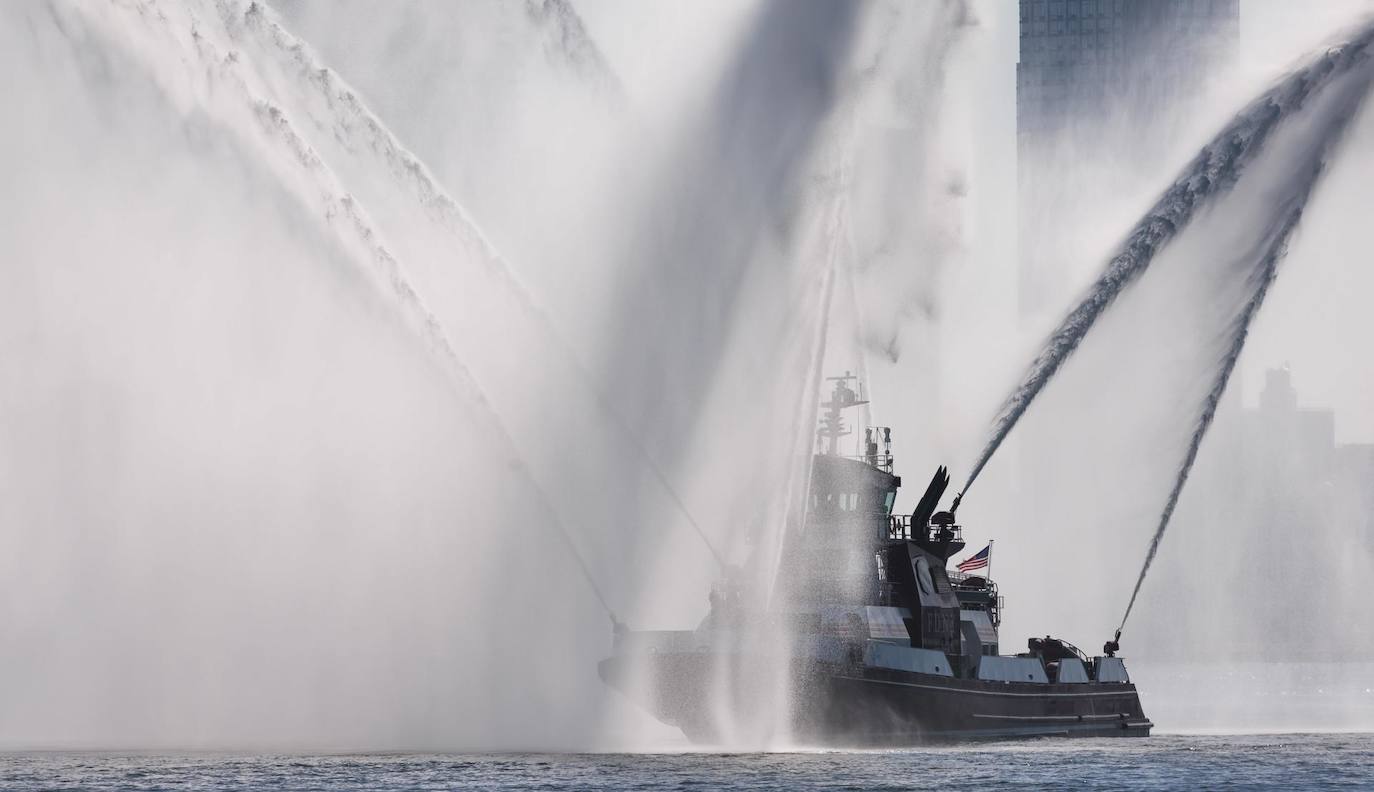 Un buque del Departamento de Bomberos de Nueva York rocía agua como parte de una guardia de honor reunida durante el traslado digno del cuerpo del oficial de policía de Nueva York Adeed Fayaz, quien fue asesinado esta semana, en Nueva York, Nueva York, EE. UU.. Fayaz recibió un disparo y herido de muerte mientras estaba fuera de servicio.