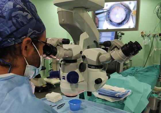 Un médico prepara una córnea para implantársela a un paciente durante un trasplante.