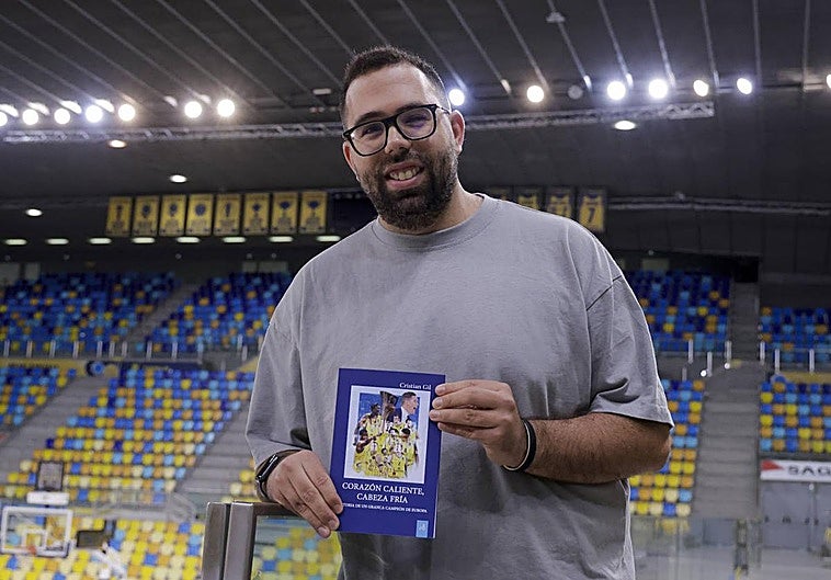 El periodista Cristian Gil posa con su libro para Canarias7 en el Gran Canaria Arena.