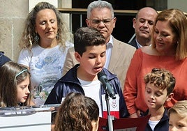 Un escolar lee el manifiesto junto a Astrid Pérez.