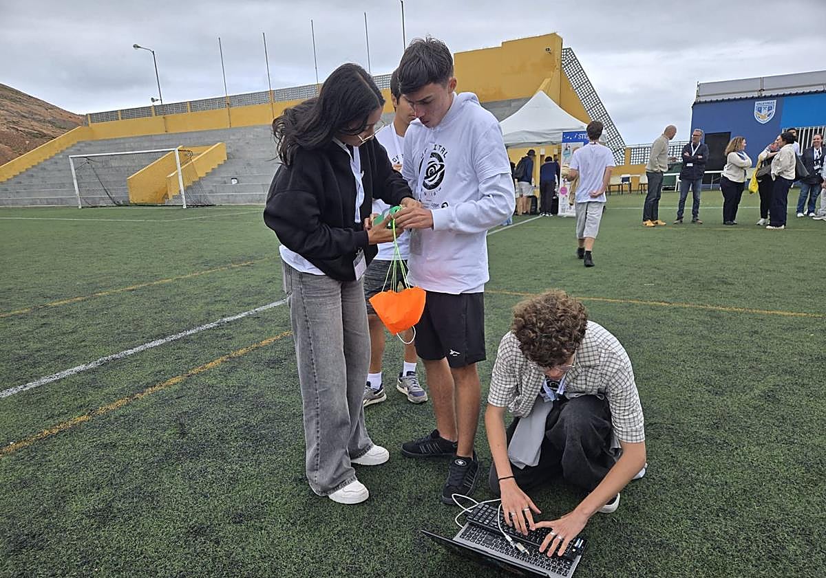 Imagen principal - En la foto superior y debajo, dos momentos de la competición en la fase regional de Canarias, en Guía. Al lado, de repaso, viendo los vídeos en clase.