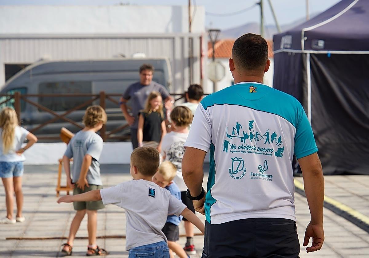 Niños practican el juego de la pelotamano.