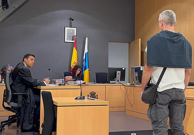 El condenado, de espaldas, junto a su letrado Fidel Rodríguez.