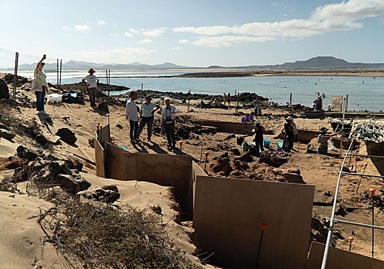 El yacimiento del taller romano de púrpura de la isla de Lobos, con la costa de Corralejo al fondo.