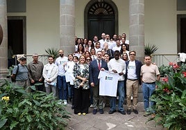Personal y alumnado de Radio ECCA posan en el Parlamento junto a Poli Suárez tras aprobarse la ley.