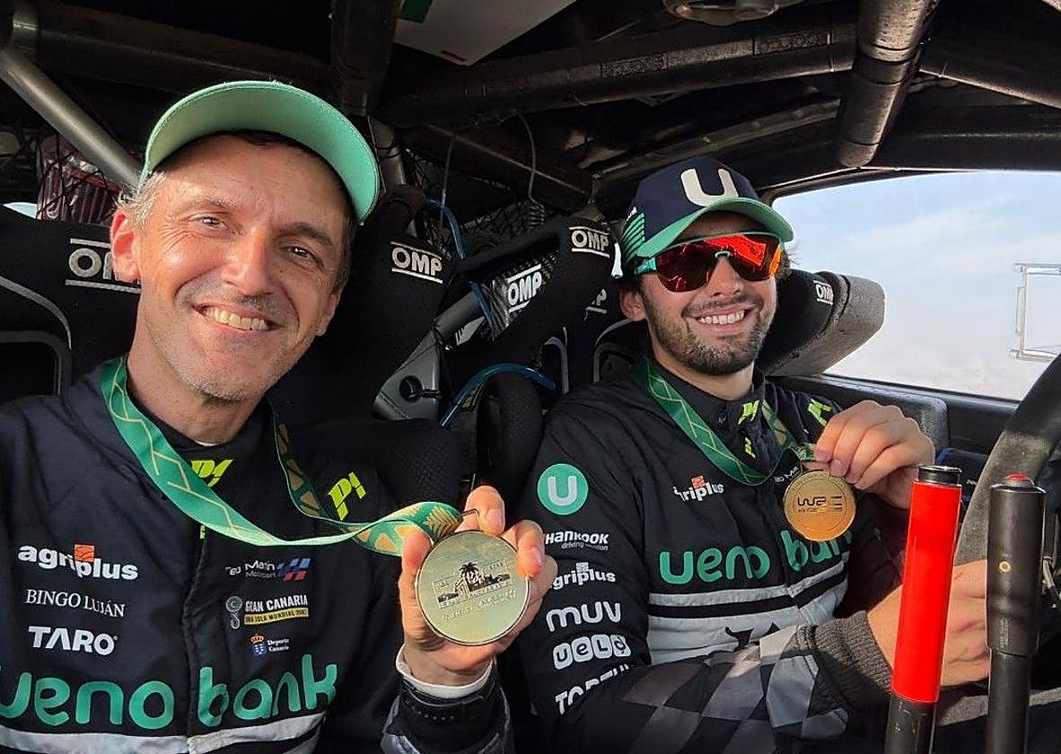 Rogelio Peñate muesrra su medalla junto a Diego Domínguez.