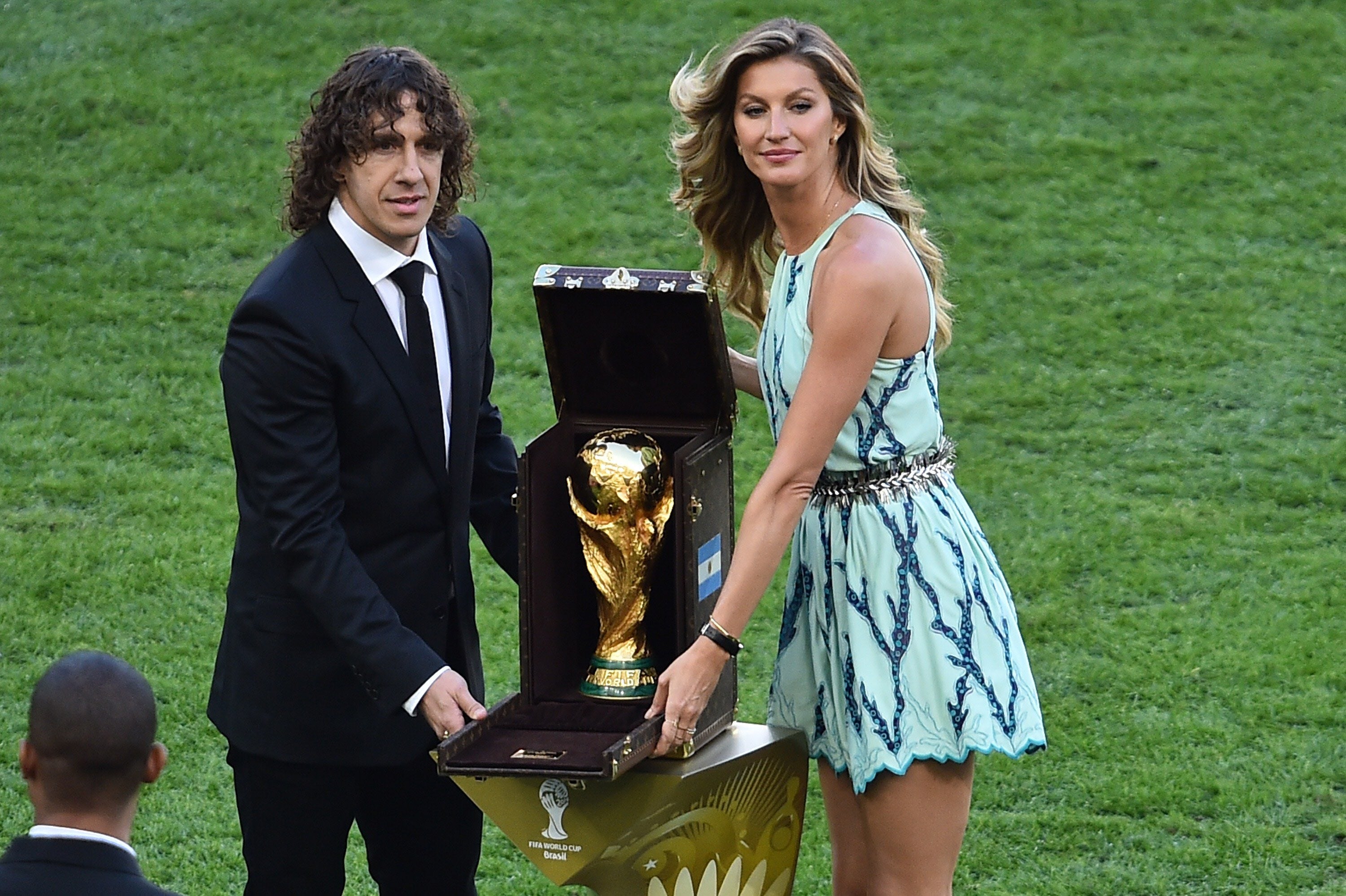 Carles Puyol y la modelo Gisele Büdchen muestran la copa del mundo antes del partido.