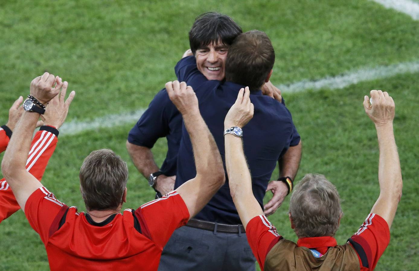 Joaquim Löw (arriba) se abraza con miembros de su equipo técnico.