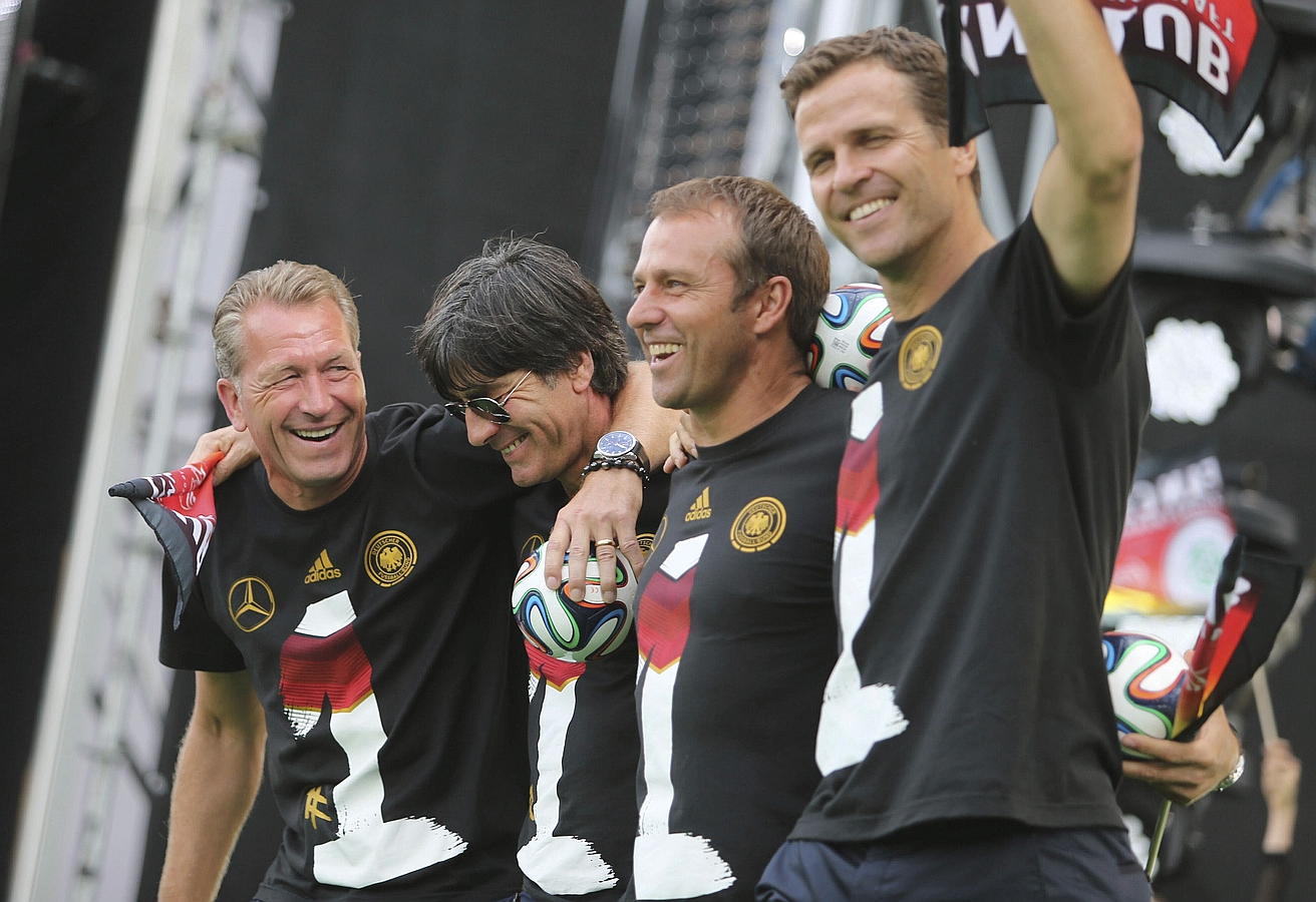 LA SELECCIÓN ALEMANA CELEBRA LA COPA DEL MUNDO CON MILES DE AFICIONADOS. El entrenador de porteros de la selección alemana de fútbol, Andreas Köpke (i-d), el seleccionador, Joachim Löw, el ayudante del seleccionador, Hansi Flick, y el director deportivo, Oliver Bierhoff, celebran la victoria de su selección en el Mundial de fútbol de Brasil 2014 con los cientos de miles de aficionados que recibieron al combinado alemán en la Puerta de Brandeburgo en Berlín.