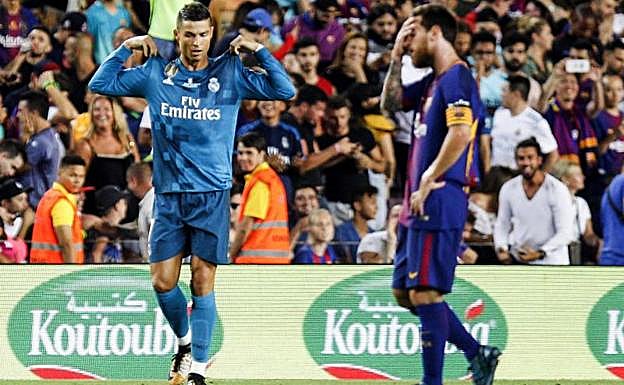 Cristiano Ronaldo (izq.) celebra un gol ante Leo Messi.