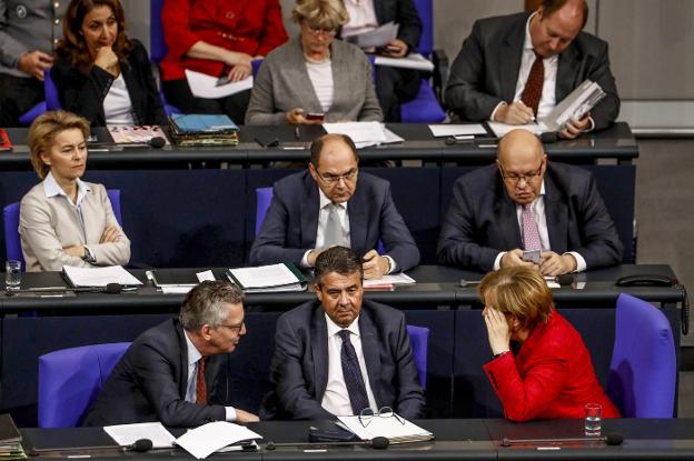 Sigmar Gabriel, en el centro, Angela Merkel y el ministro de Interior, Thomas de Maiziere, durante una sesión en el Bundestag. :: afp