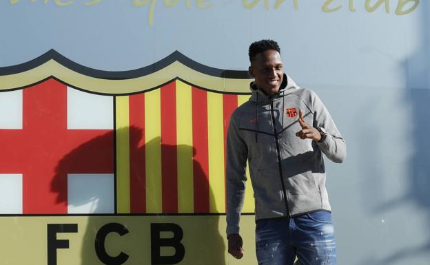 Yerry Mina posa con el escudo del Barcelona. 