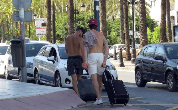 Imagen del pasado verano en Marbella con turistas paseando sin camiseta. 