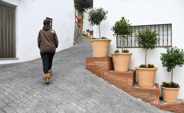 Una vecina paseando por una calle de Pujerra. 