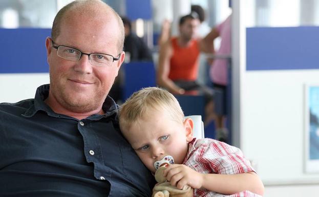 Un padre con su hijo en una sala de espera. 