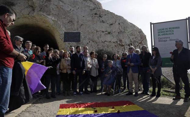 Imagen principal - La imagen superior muestra a los asistentes al acto de homenaje en el lugar de la placa conmemorativa a las víctimas de la carretera Málaga-Almería. Por debajo, unas rosas flotando en la orilla y una mujer que ha acudido al acto. 