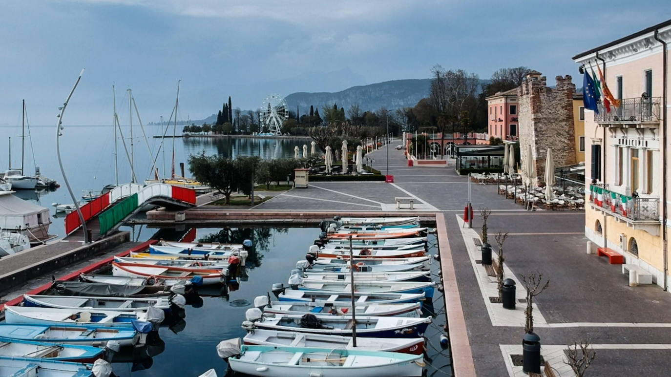 El puerto y el paseo marítimo de Bardolino desiertos, en la costa oriental del lago de Garda, Verona (Italia).