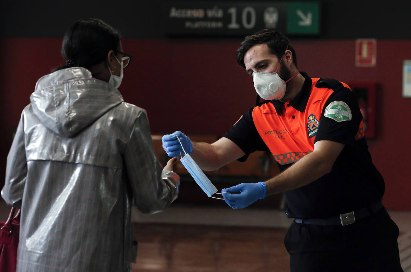 El estado de alarma deja estampas inéditas. Protección Civil comienza en Málaga el reparto de mascarillas a los trabajadores en los transportes públicos.