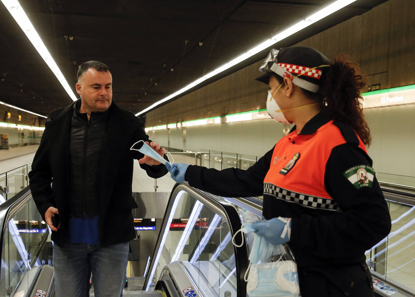 El estado de alarma deja estampas inéditas. Protección Civil comienza en Málaga el reparto de mascarillas a los trabajadores en los transportes públicos.