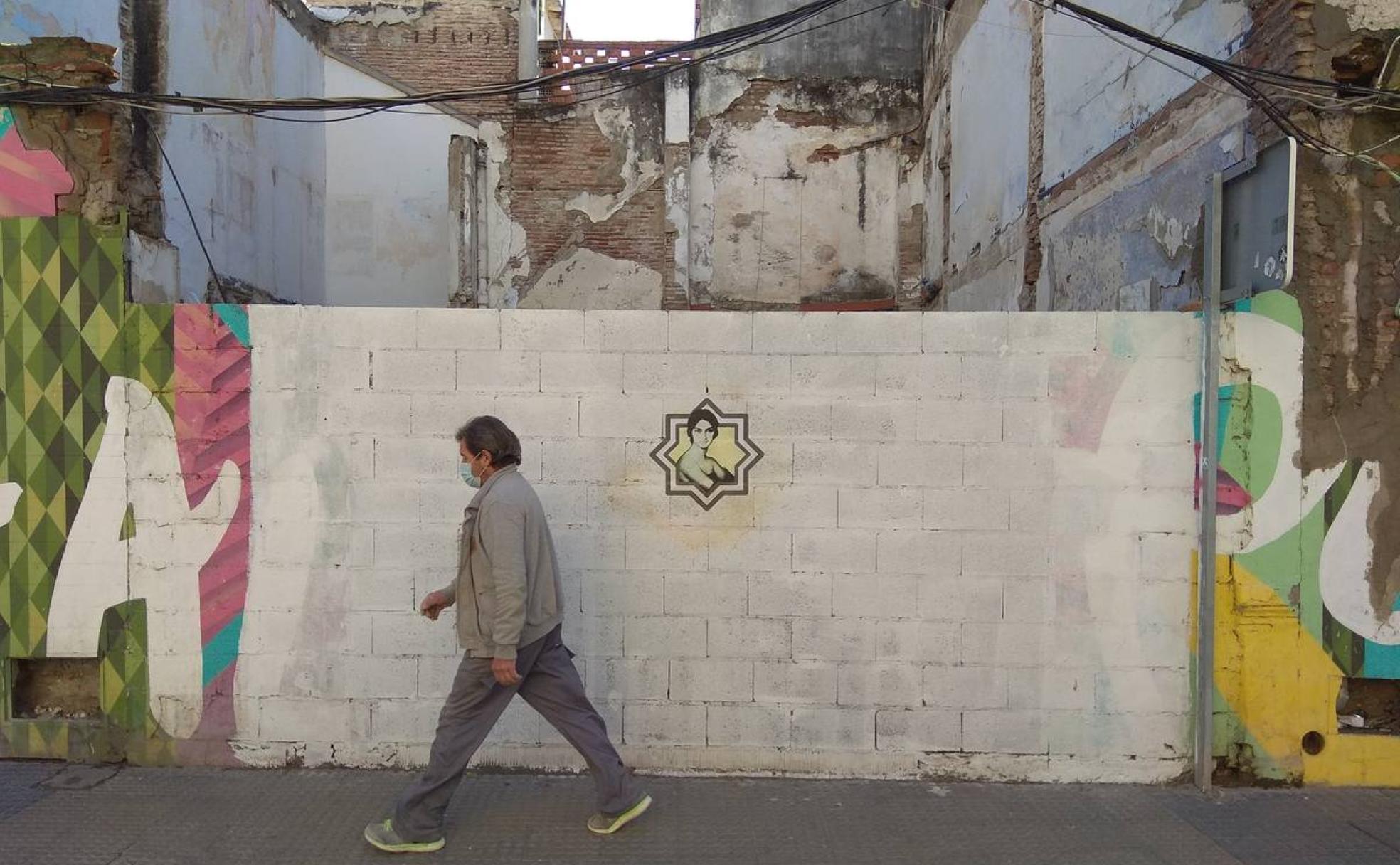 La obra de Julio Romero de Torres, rodeada por la estrella tartésica en una de las calles de Lagunillas. 