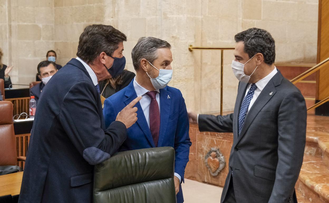 Juan Bravo, en el salón de plenos junto al presidente de la Junta, Juanma Moreno, y el vicepresidente, Juan Marín.
