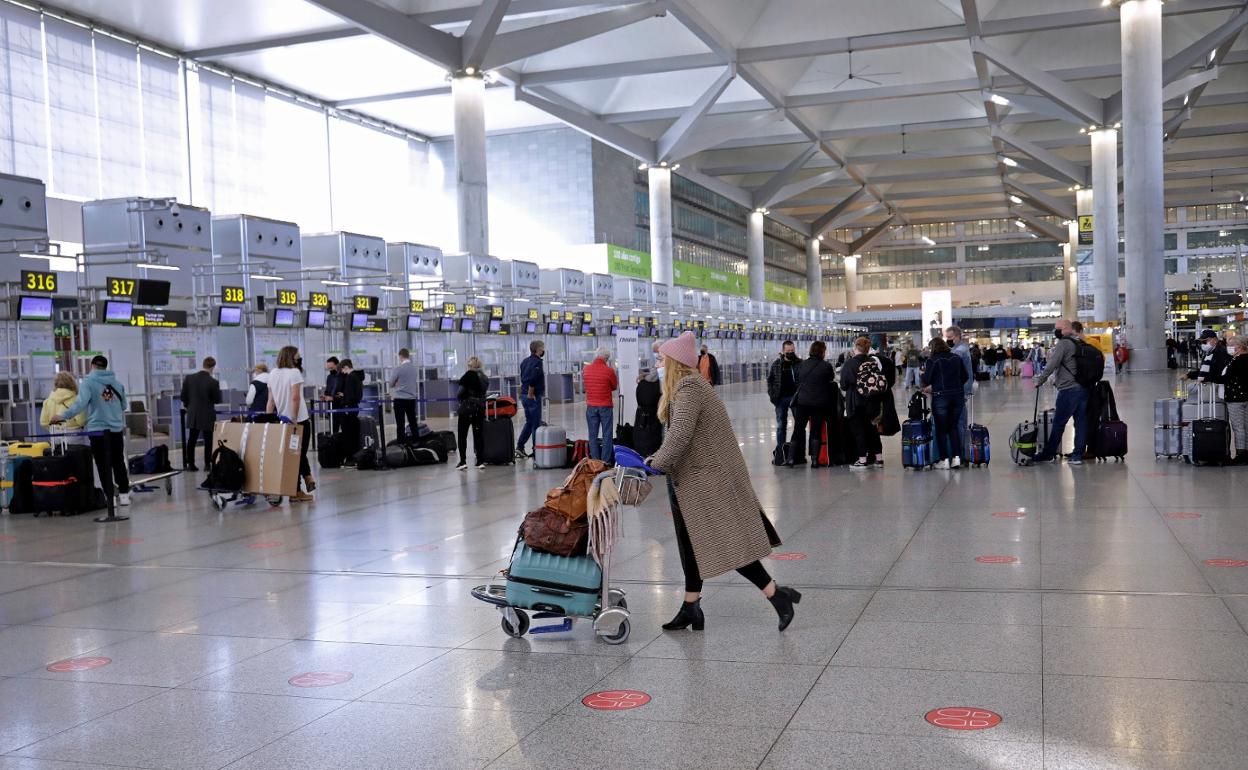 Turistas se disponen a facturar sus equipajes en el aeropuerto tras la estancia en la Costa del Sol. 