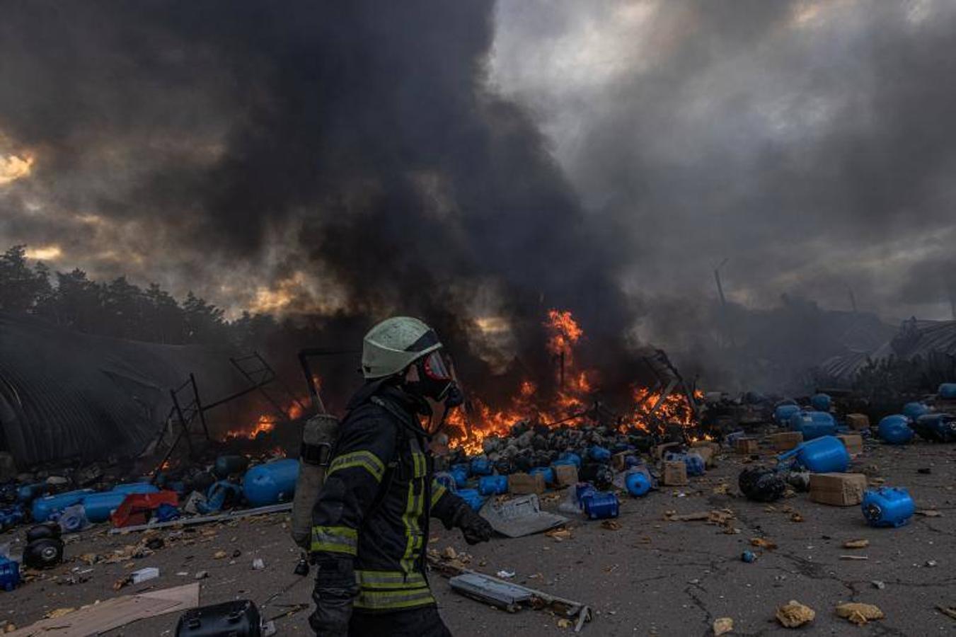Un bombero ucraniano trata de extinguir el fuego en un almacenamiento de productos químicos que fue alcanzado por bombardeos rusos.