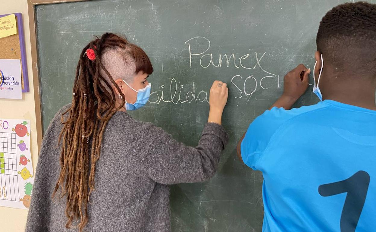 La psicóloga Sara Olivares, con uno de los menores que atienden en el programa PAMEX.