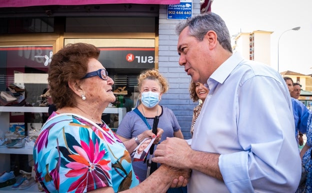 Espadas charla con unas vecinas durante su visita esta mañana al sevillano barrio de Parque Alcosa.