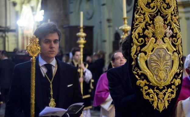 El hermano mayor del Cristo de la Clemencia junto al guión corporativo. 