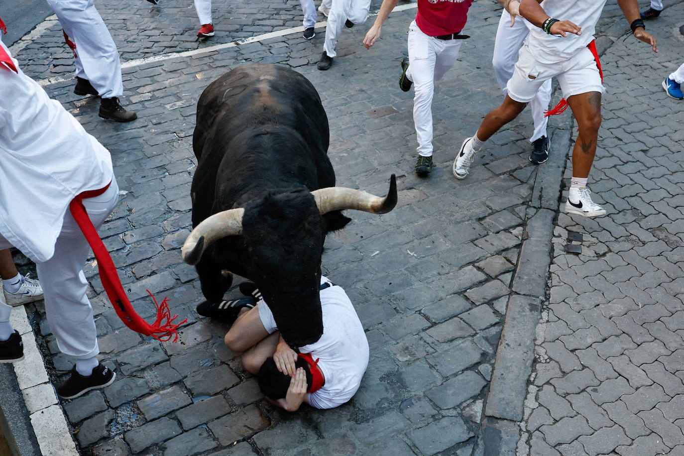 Un mozo cae durante el sexto encierro de San Fermín. 