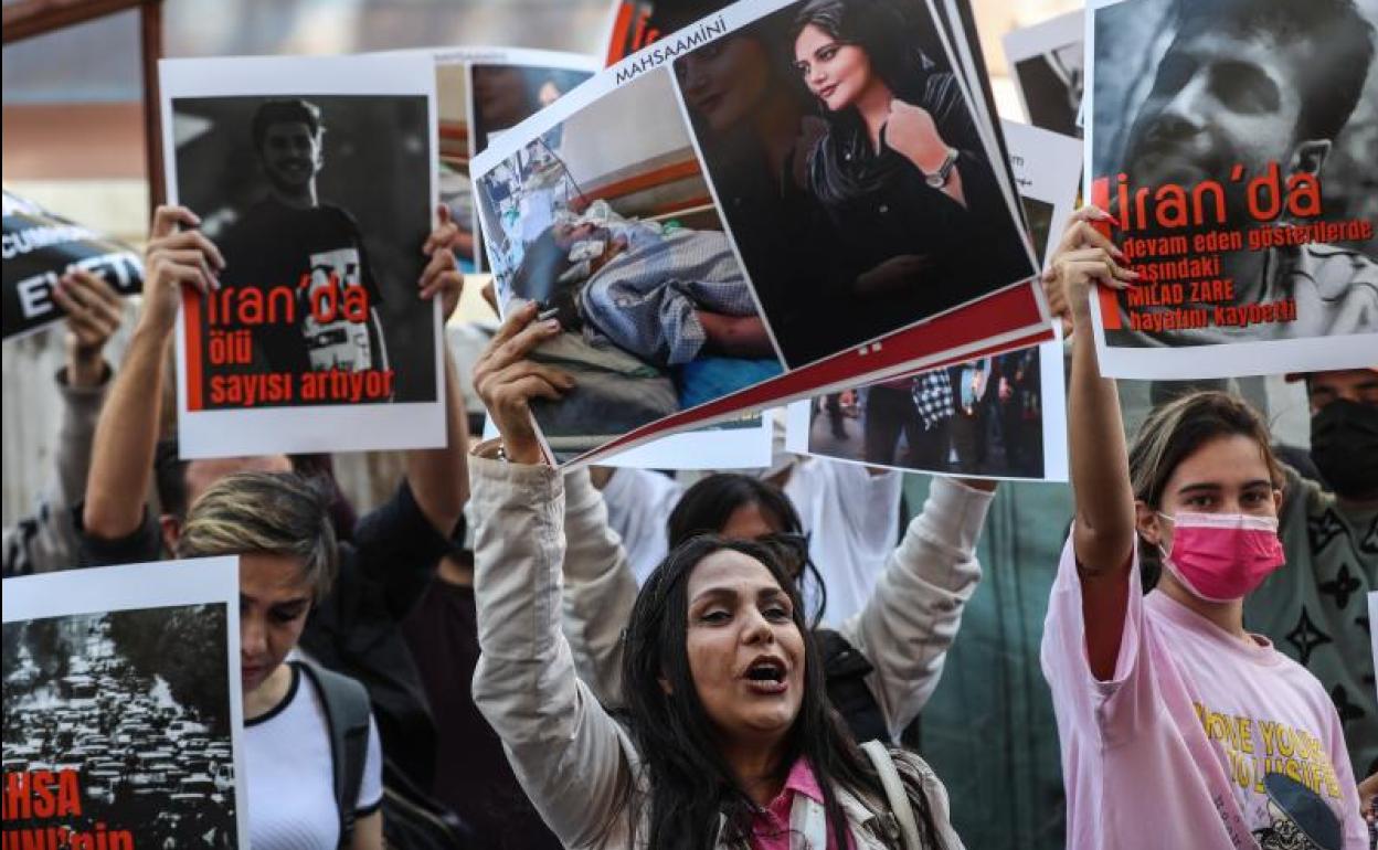 Un grupo de iraníes sostiene fotografías de Mahsa Amini durante una protesta frente al consulado de Irán tras la muerte de Mahsa Amini en Estambul, Turquía. 