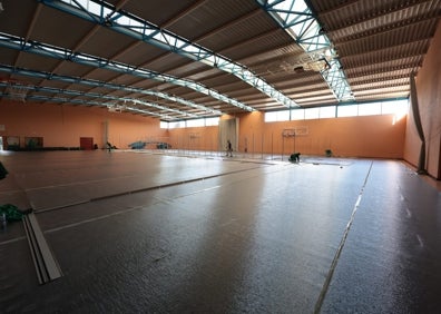 Imagen secundaria 1 - Arriba, las dos pistas auxiliares de entrenamiento en el exterior del Carpena, en una gran cara negra; sobre estas líneas, la pista anexa del Carpena en la que se empieza a levantar los ocho vestuarios prefabricados de los equipos, y a la derecha, los banquilllos de los equipos. 