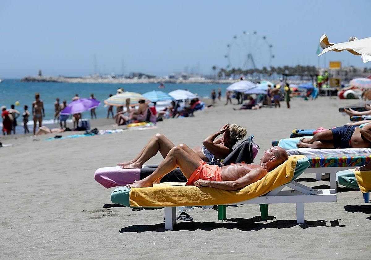 Turistas disfrutan del sol y de la playa en la costa de Torremolinos.