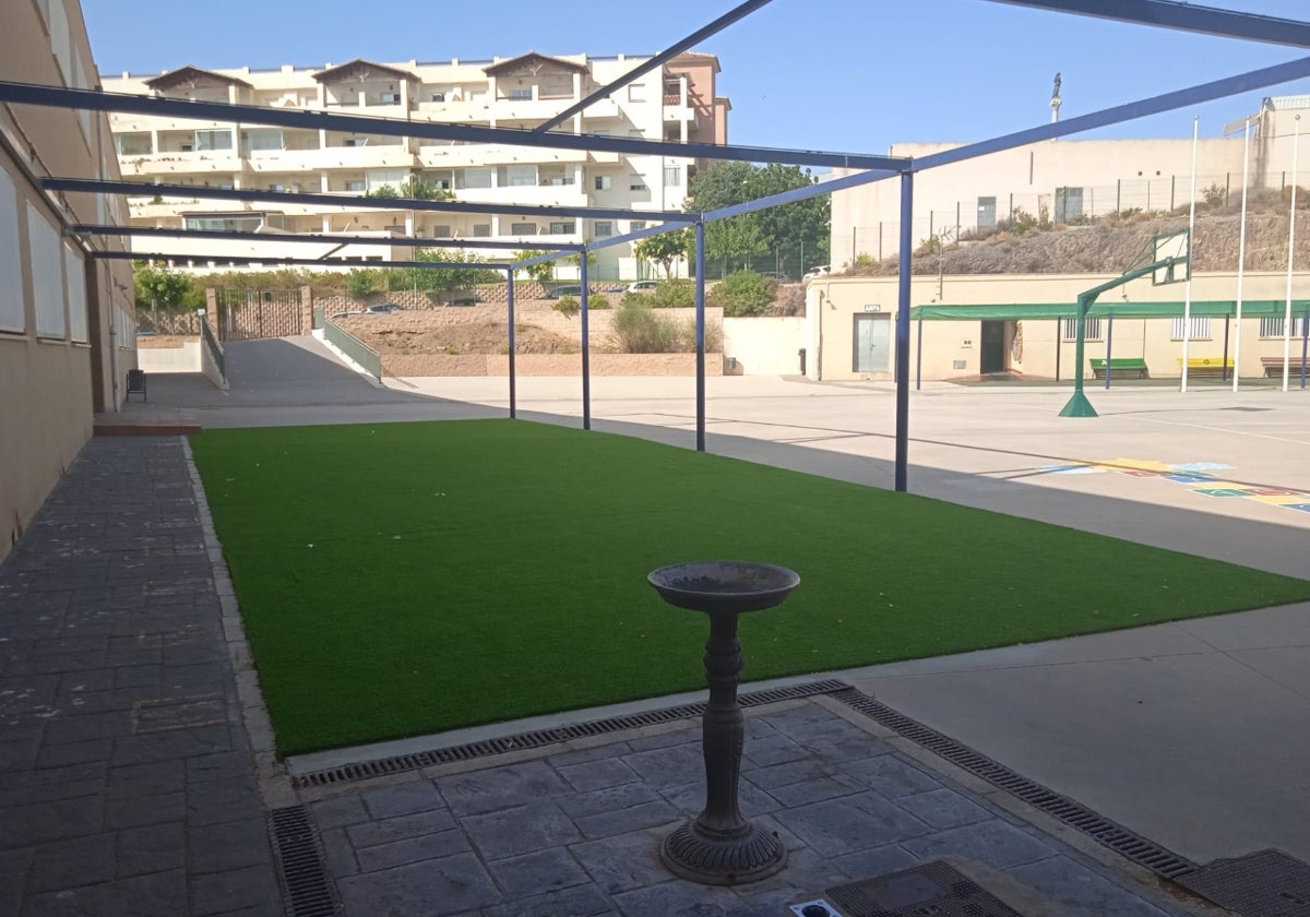 Vista del patio del centro educativo, con una fuente en primer plano.