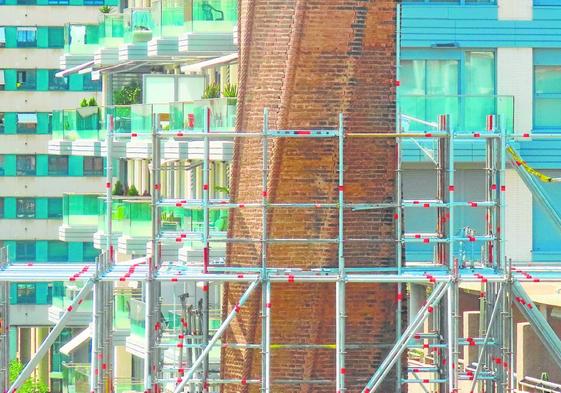 Trabajadores de la construcción en las labores de rehabilitación de una de las chimeneas históricas de la capital.